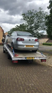 White Recovery | Car Recovery Service in London – Breakdown Recovery | White Recovery A silver car securely strapped on a flatbed recovery truck in Paddington, W2. White Recovery providing expert towing and breakdown recovery services.