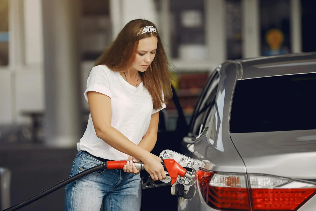 Woman refuelling a car at a petrol station – guide to what to do if you put the wrong fuel in your vehicle in London
