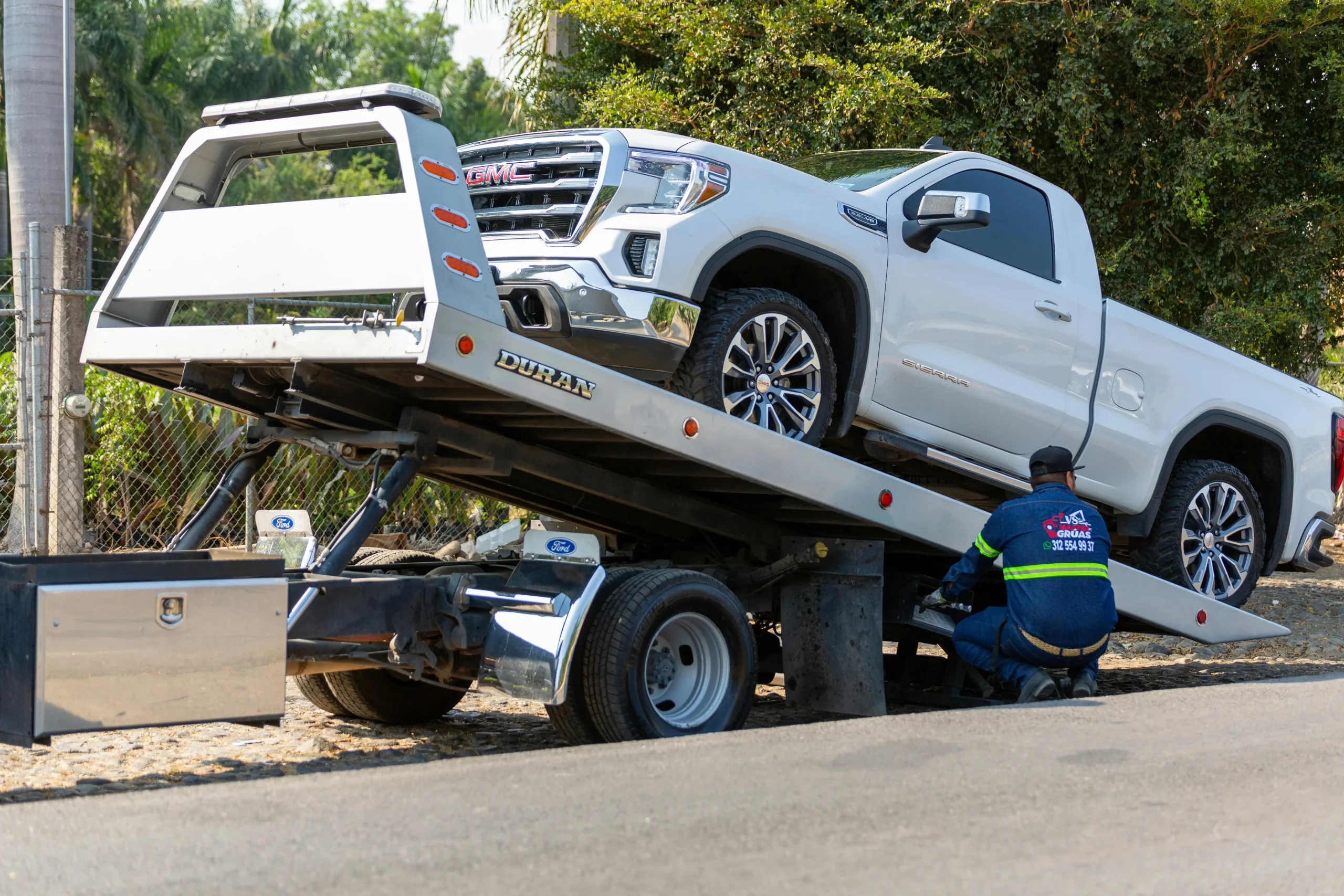 White truck being loaded onto a tow truck by White Recovery for vehicle recovery in Ilford