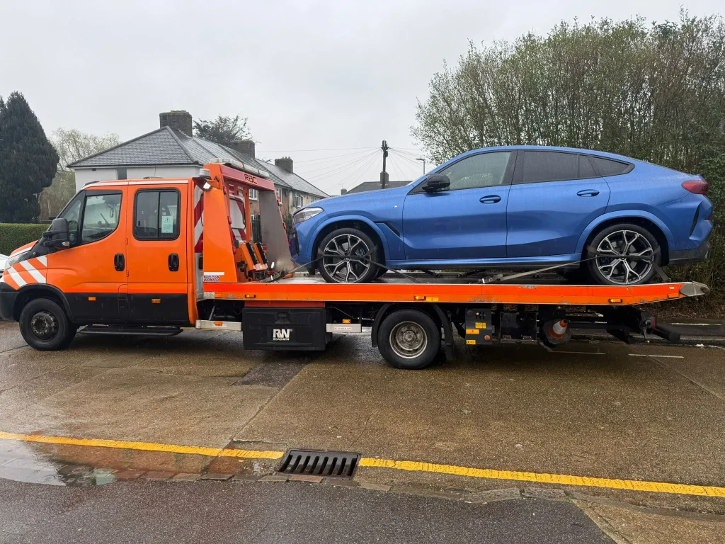 Blue BMW SUV loaded onto a recovery truck by White Recovery providing car and van recovery services in Barking