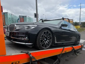 Black BMW luxury saloon vehicle being recovered on a flatbed recovery truck in Bow by White Recovery