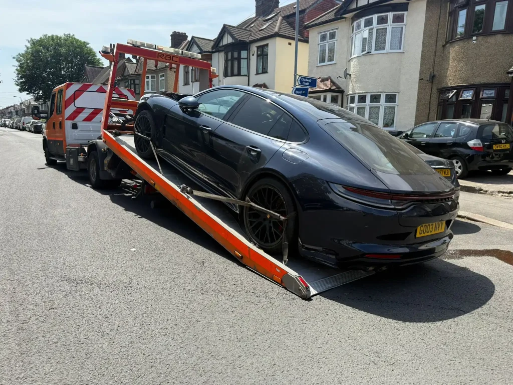 24-hour car and van recovery service in Chiswick London by White Recovery transporting a luxury sports car on a recovery truck