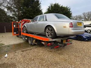 Silver Rolls-Royce luxury car secured on a recovery truck by White Recovery providing vehicle recovery services in Ilford