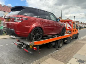 Red Range Rover Sport loaded onto a recovery truck in Whitechapel by White Recovery roadside assistance team