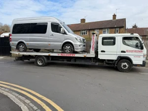 Silver Mercedes Sprinter van loaded onto a recovery truck by White Recovery providing van recovery services in Rainham