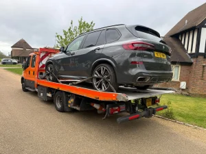 BMW X5 SUV being transported on a recovery truck by WhiteRecovery recovery service in Fenchurch Street London