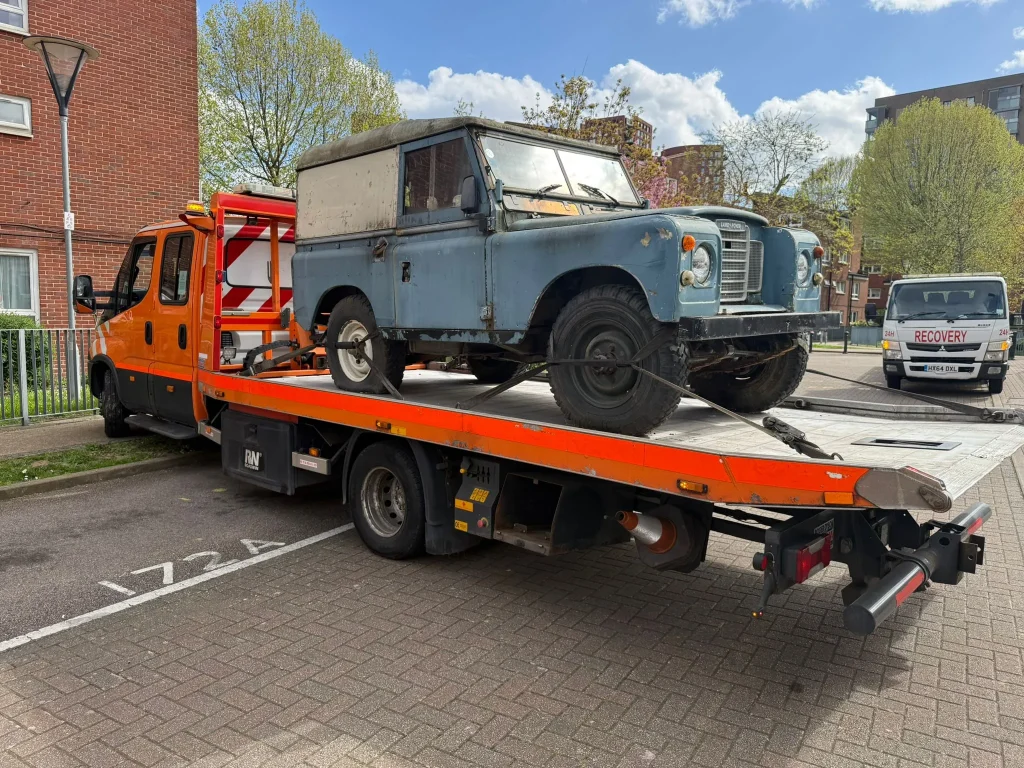 Vintage Land Rover being transported on a recovery truck by White Recovery in Dagenham for 24-hour vehicle recovery service.