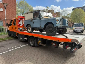White Recovery | Car Recovery Service in London – Breakdown Recovery | White Recovery Vintage Land Rover being transported on a recovery truck by White Recovery in Dagenham for 24-hour vehicle recovery service.