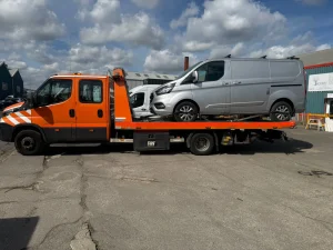 Ford Transit van being transported on a flatbed recovery truck by WhiteRecovery in Fleet Street London