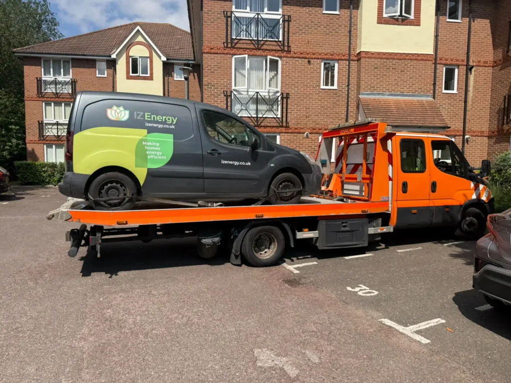 Commercial van loaded onto a White Recovery tow truck for professional van recovery service in Gidea Park, London.