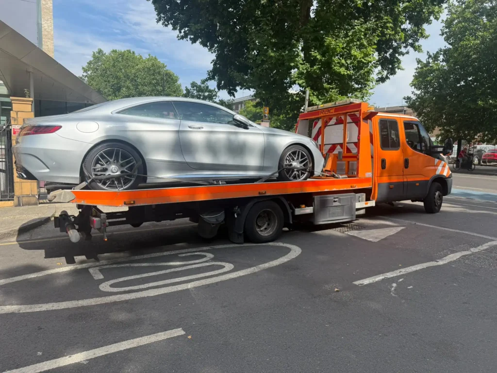 Silver Mercedes car secured on a flatbed recovery truck for vehicle recovery in Croydon.