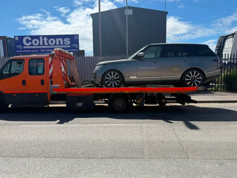 Car recovery truck transporting a Range Rover in Chelsea