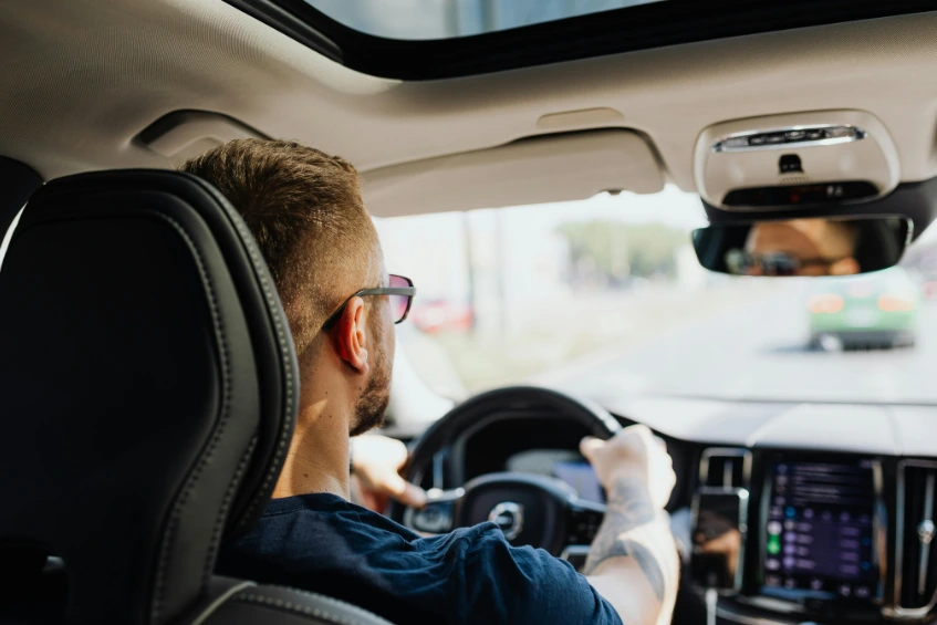 Driver inside a car noticing unusual smells while driving