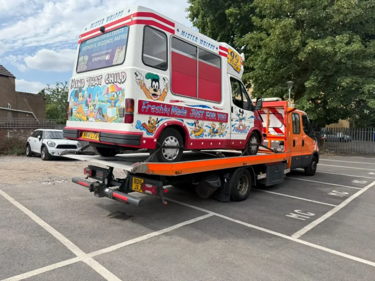 White Recovery truck transporting a van in Hammersmith