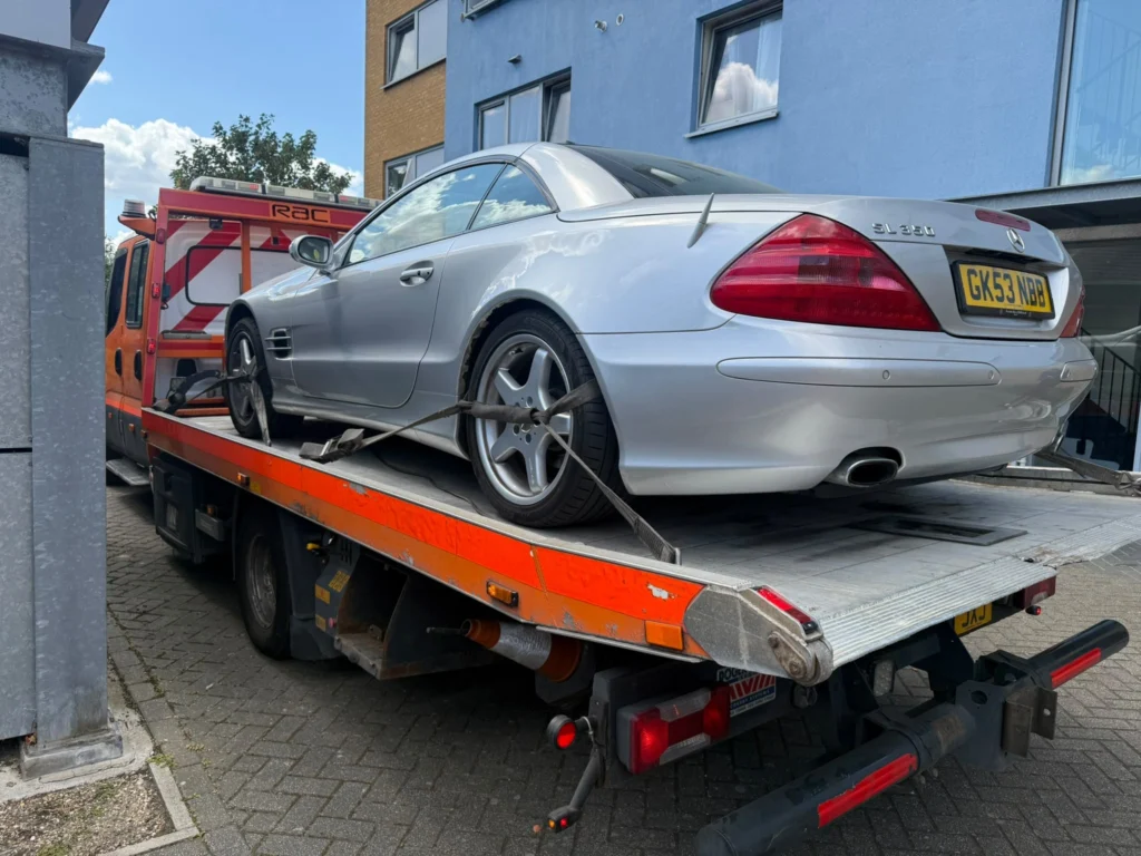 Silver Mercedes-Benz SL 350 secured on a flatbed recovery truck for vehicle recovery in Southend.